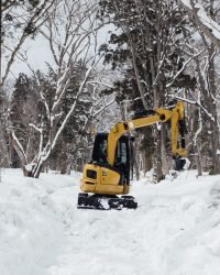 backhoe in snow at togakushi shrine, japan
