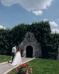 Weeding beautiful backview of a married couple in front of entrance in