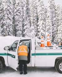 person standing near car with traffic cones (1)